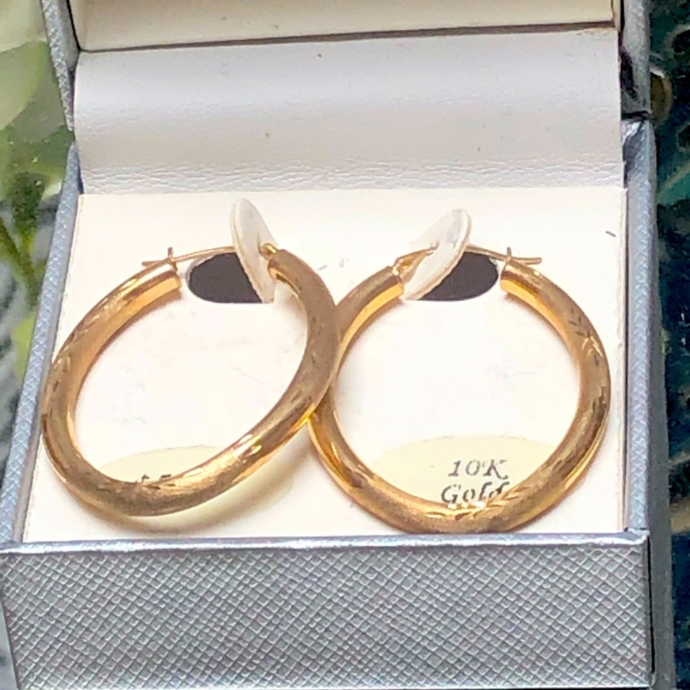Slim 10k gold hoop earrings have
delicate engravings and a high polish